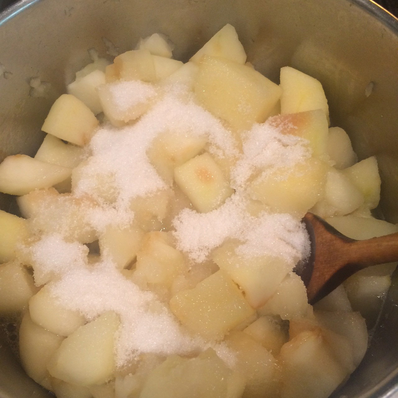stirring sugar into apple cubes